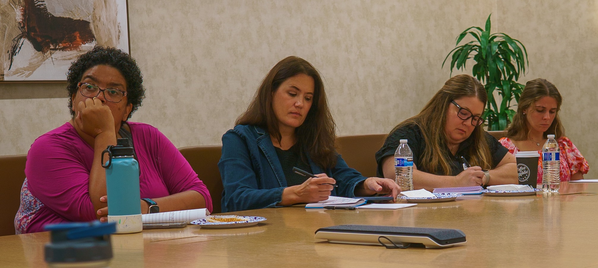 Attendee taking notes at Friday Morning Fundraising