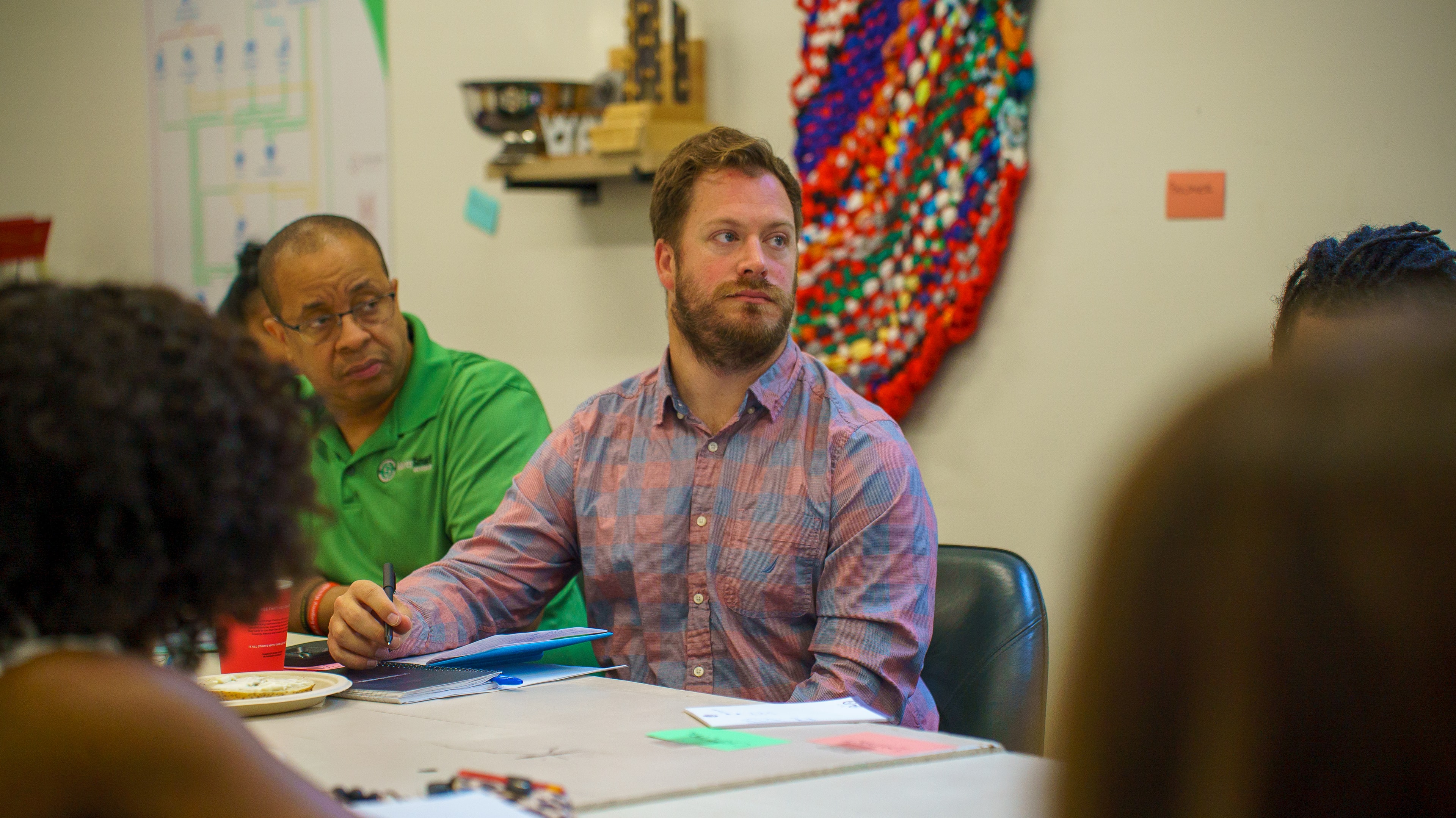 Two attendees listening together at Friday Morning Fundraising